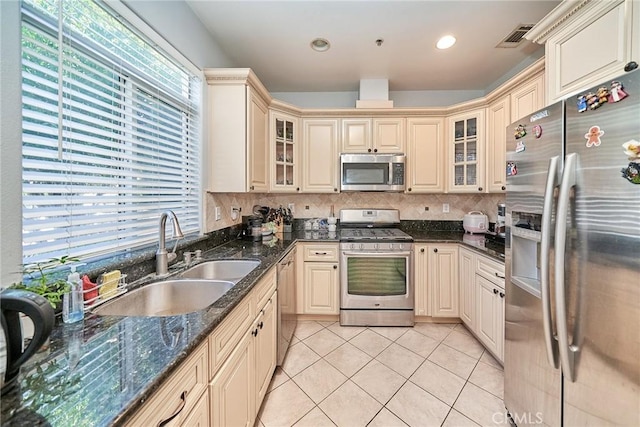 kitchen with light tile patterned floors, visible vents, a sink, appliances with stainless steel finishes, and cream cabinets