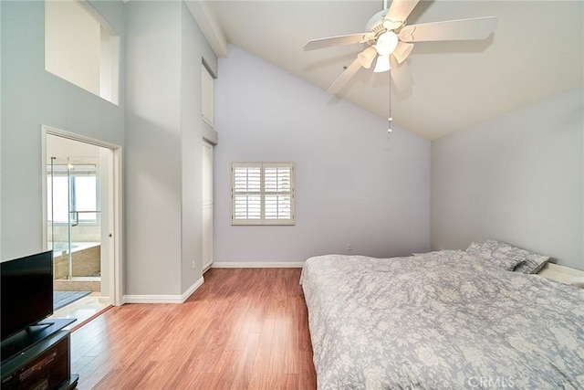 bedroom featuring baseboards, multiple windows, and light wood-style floors