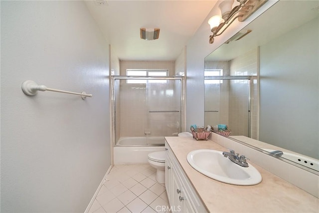 bathroom featuring vanity, baseboards, enclosed tub / shower combo, tile patterned flooring, and toilet