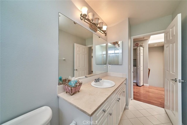 bathroom featuring tile patterned floors, toilet, and vanity