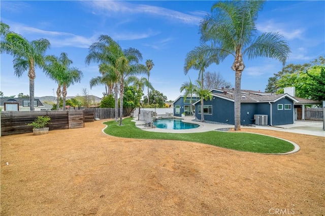 view of yard with a fenced backyard, a fenced in pool, cooling unit, and a patio