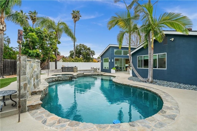 view of swimming pool with a fenced in pool, an in ground hot tub, a fenced backyard, and a patio area