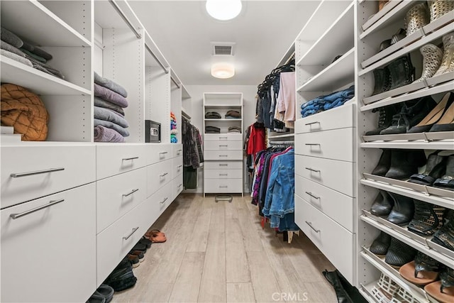 spacious closet with light wood-style flooring and visible vents