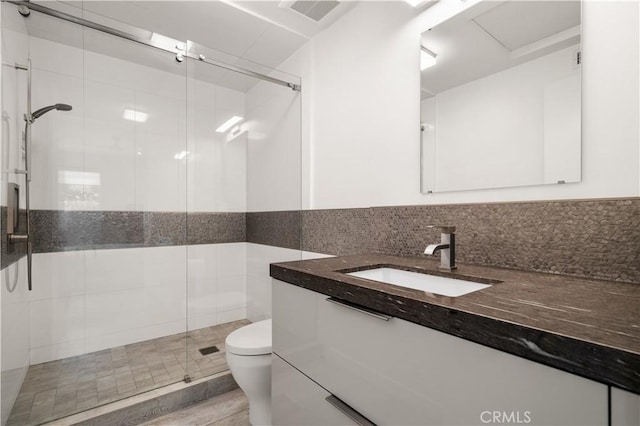 full bath featuring visible vents, a stall shower, toilet, and vanity