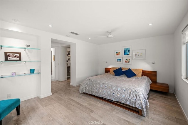 bedroom with recessed lighting, visible vents, baseboards, and wood finished floors