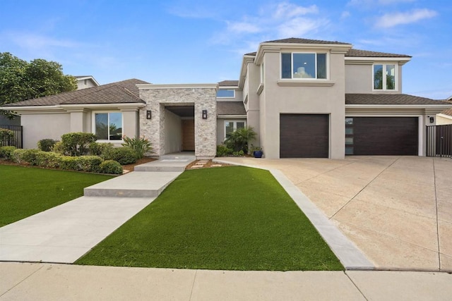 prairie-style home with a front lawn, concrete driveway, a garage, and stucco siding