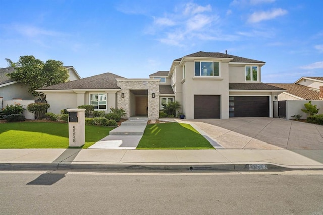 view of front facade with fence, concrete driveway, a front yard, stucco siding, and an attached garage