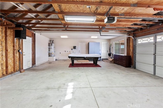 garage with secured water heater and a garage door opener