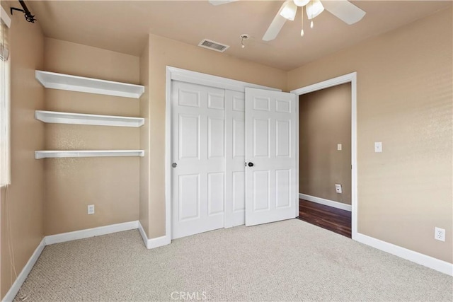 unfurnished bedroom featuring visible vents, ceiling fan, baseboards, carpet floors, and a closet