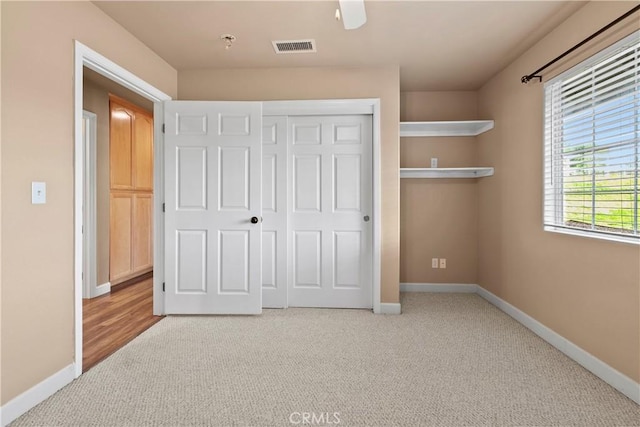 unfurnished bedroom featuring visible vents, a ceiling fan, a closet, carpet, and baseboards