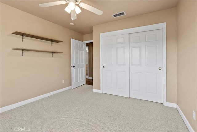 unfurnished bedroom with visible vents, baseboards, ceiling fan, a closet, and light carpet