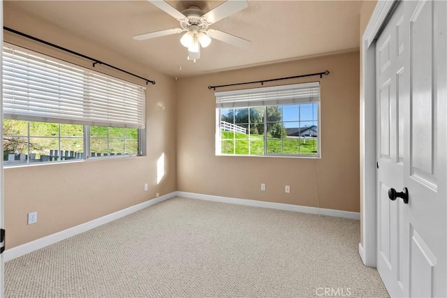 unfurnished bedroom with a closet, multiple windows, baseboards, and carpet flooring