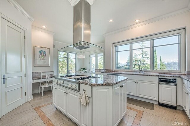 50369 Rd 420, Coarsegold, CA 93614 - kitchen with island range hood, inlaid floor details, stainless steel gas cooktop, ornamental molding, and white cabinetry