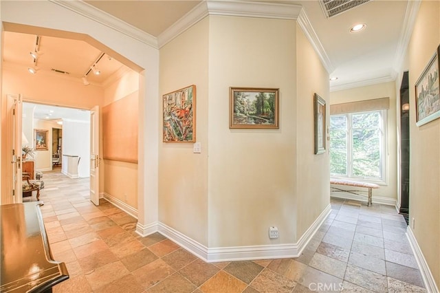 corridor featuring visible vents, crown molding, baseboards, recessed lighting, and stone tile flooring