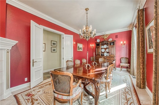 dining room with a chandelier, baseboards, and ornamental molding