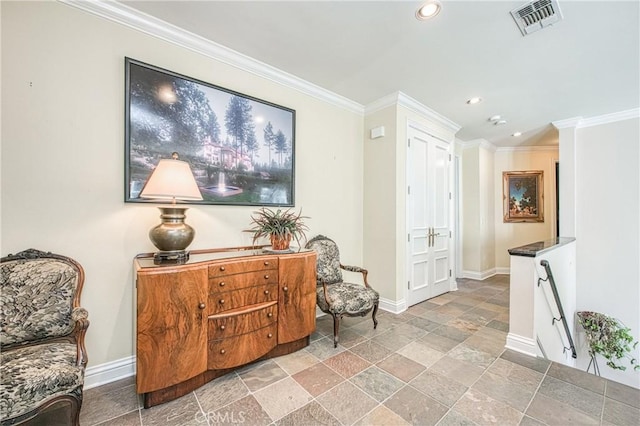 living area featuring crown molding, stone tile floors, and baseboards