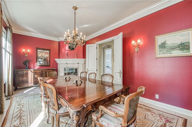 dining space with a tiled fireplace, a chandelier, crown molding, and baseboards