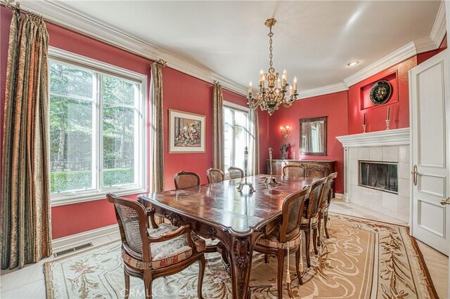 50369 Rd 420, Coarsegold, CA 93614 - dining area with a chandelier, ornamental molding, baseboards, a tile fireplace, and light tile patterned flooring