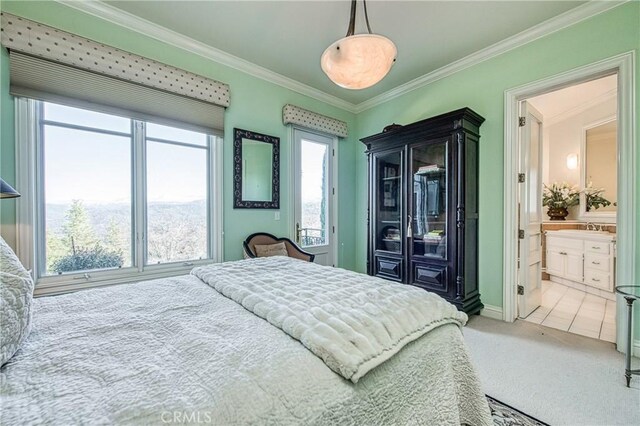 carpeted bedroom with ensuite bath, multiple windows, and ornamental molding