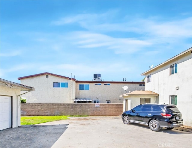 exterior space with fence and a garage