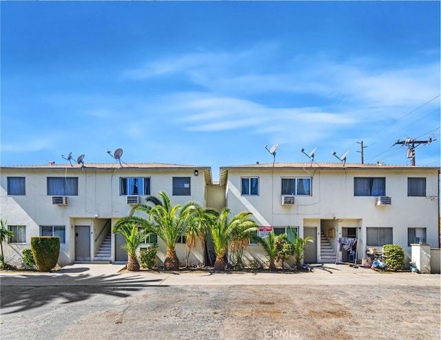 townhome / multi-family property with stairway and stucco siding