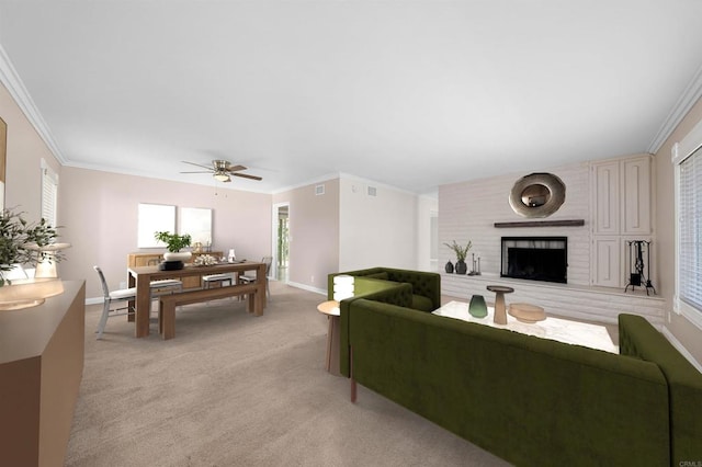 living room featuring baseboards, light carpet, ornamental molding, and a fireplace