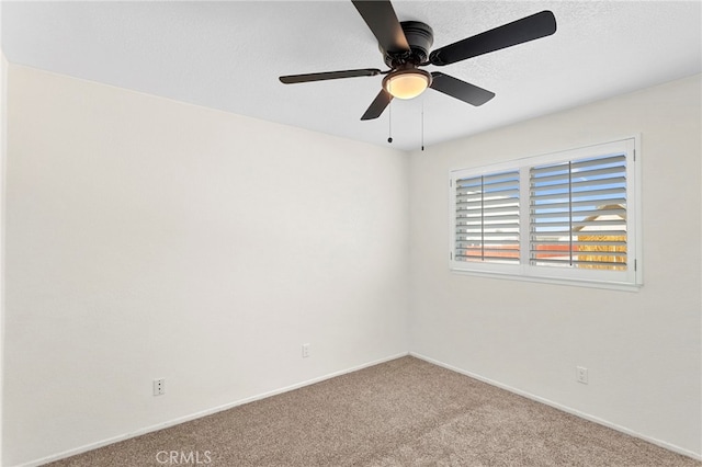 unfurnished room with ceiling fan, a textured ceiling, baseboards, and carpet floors