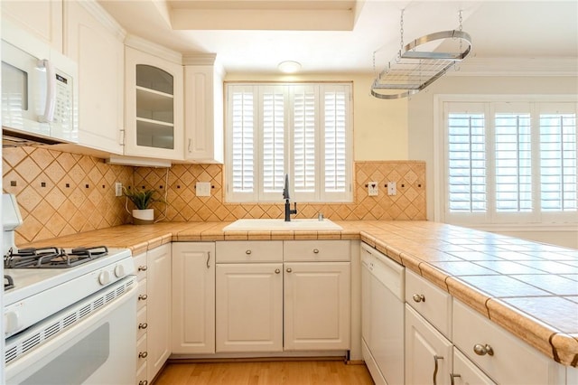 27666 Nugget Dr Unit 3, Canyon Country, CA 91387 - kitchen featuring white appliances, a sink, glass insert cabinets, light wood-style floors, and white cabinets