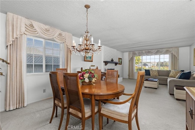 dining space with a notable chandelier, light carpet, and a textured ceiling