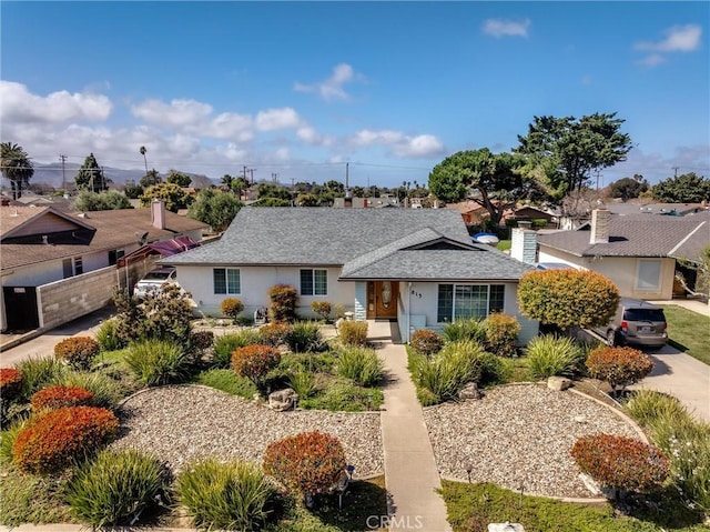 single story home featuring stucco siding and a shingled roof