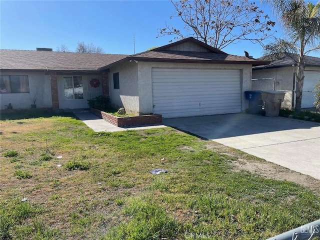 single story home featuring a garage, concrete driveway, a front lawn, and stucco siding