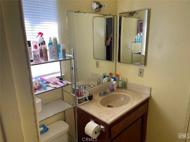 half bath featuring toilet and vanity