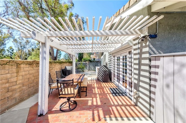 view of patio / terrace featuring a pergola, outdoor dining area, and fence