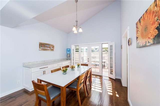 dining room featuring baseboards, high vaulted ceiling, dark wood finished floors, an inviting chandelier, and french doors