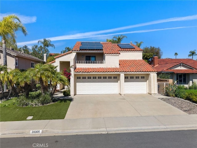 mediterranean / spanish-style home featuring stucco siding, a garage, driveway, and a tile roof