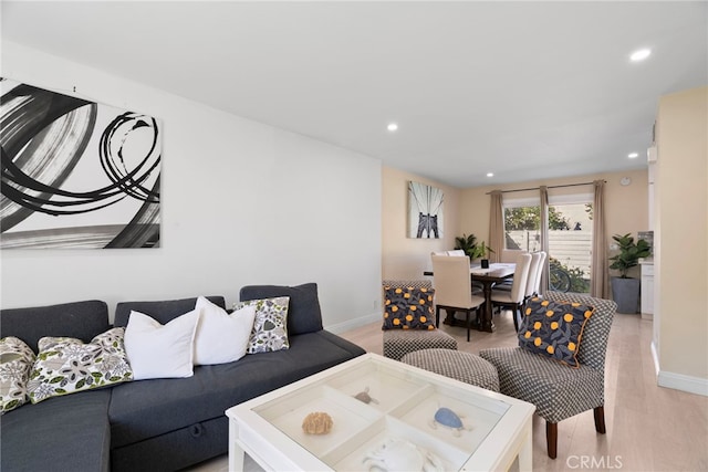 living area with recessed lighting, baseboards, and light wood-style floors