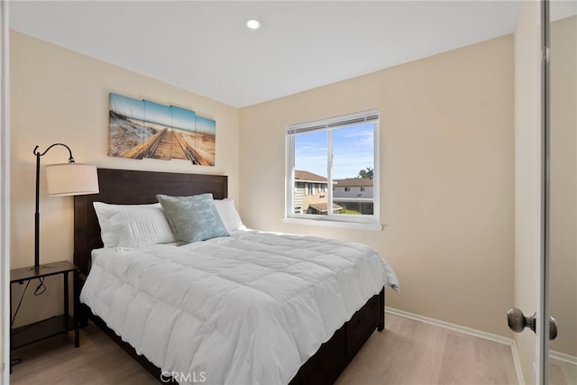 bedroom featuring recessed lighting, wood finished floors, and baseboards