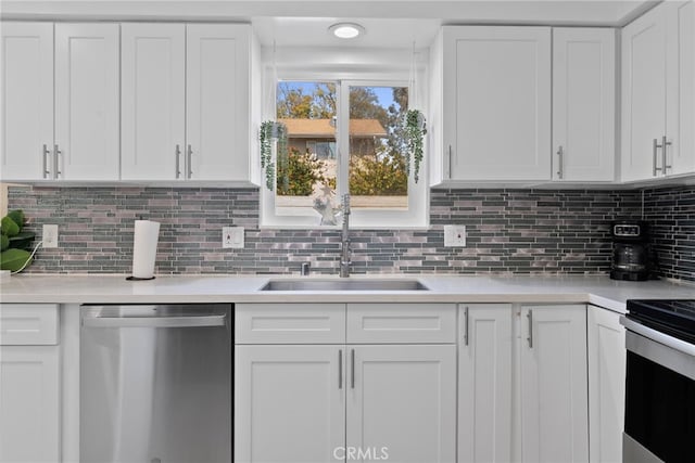 kitchen with a sink, stainless steel dishwasher, and white cabinetry