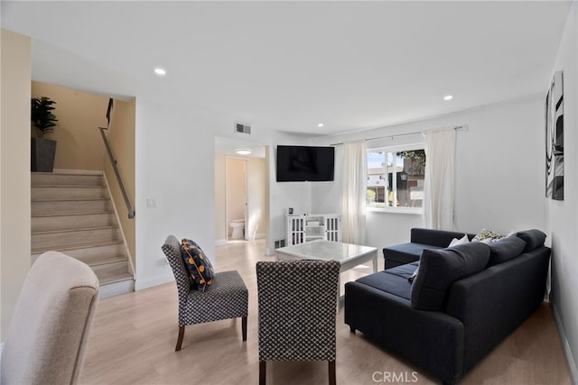 living area featuring recessed lighting, stairway, light wood-style floors, and visible vents