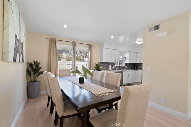 dining room with recessed lighting, visible vents, baseboards, and light wood finished floors