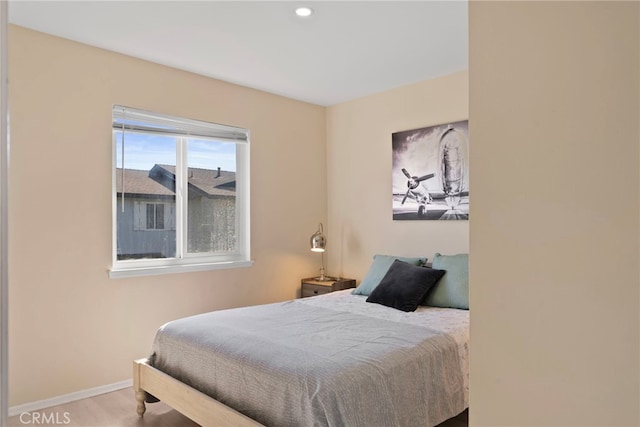 bedroom with recessed lighting, baseboards, and wood finished floors