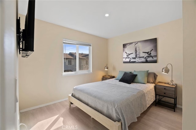 bedroom with recessed lighting, baseboards, and wood finished floors