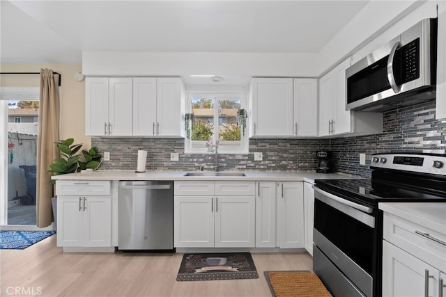 kitchen featuring a sink, appliances with stainless steel finishes, and light countertops