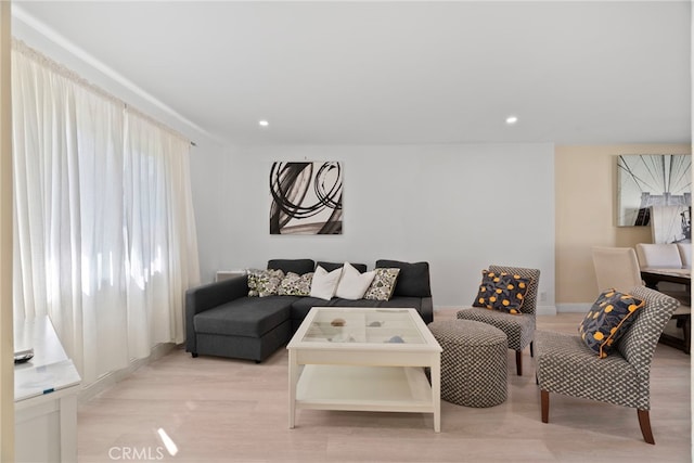 living area with recessed lighting and light wood-style flooring