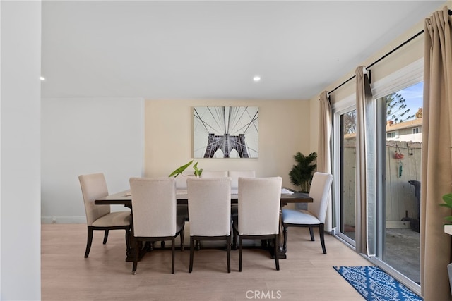 dining space with recessed lighting and wood finished floors