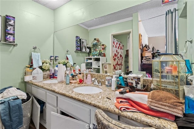 full bath with curtained shower, a textured ceiling, ornamental molding, and vanity