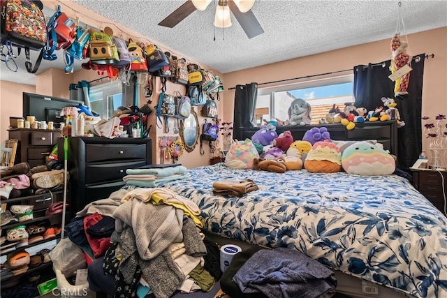 bedroom with a textured ceiling and ceiling fan