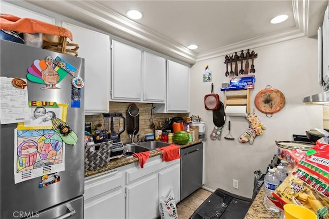 kitchen featuring tasteful backsplash, dishwasher, ornamental molding, freestanding refrigerator, and white cabinetry