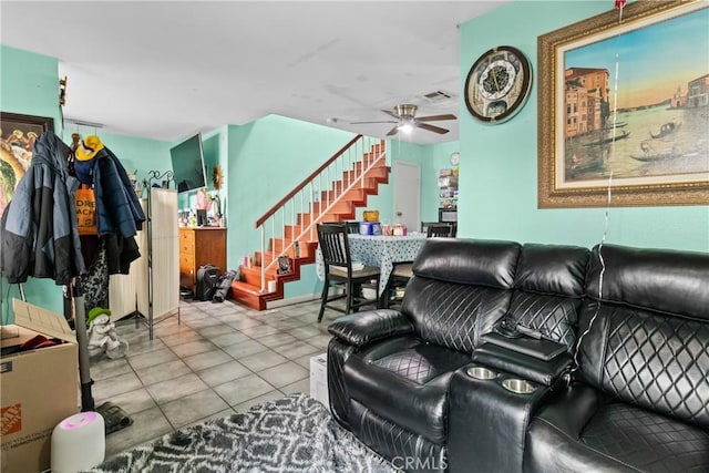 living area with stairs, tile patterned floors, a ceiling fan, and visible vents