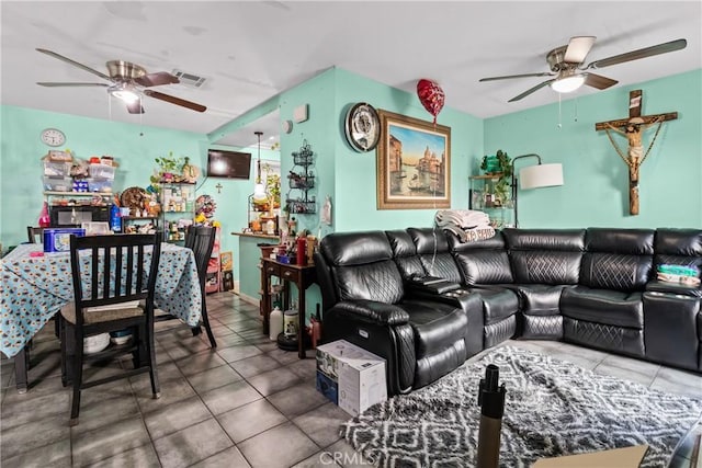 tiled living room featuring visible vents and a ceiling fan